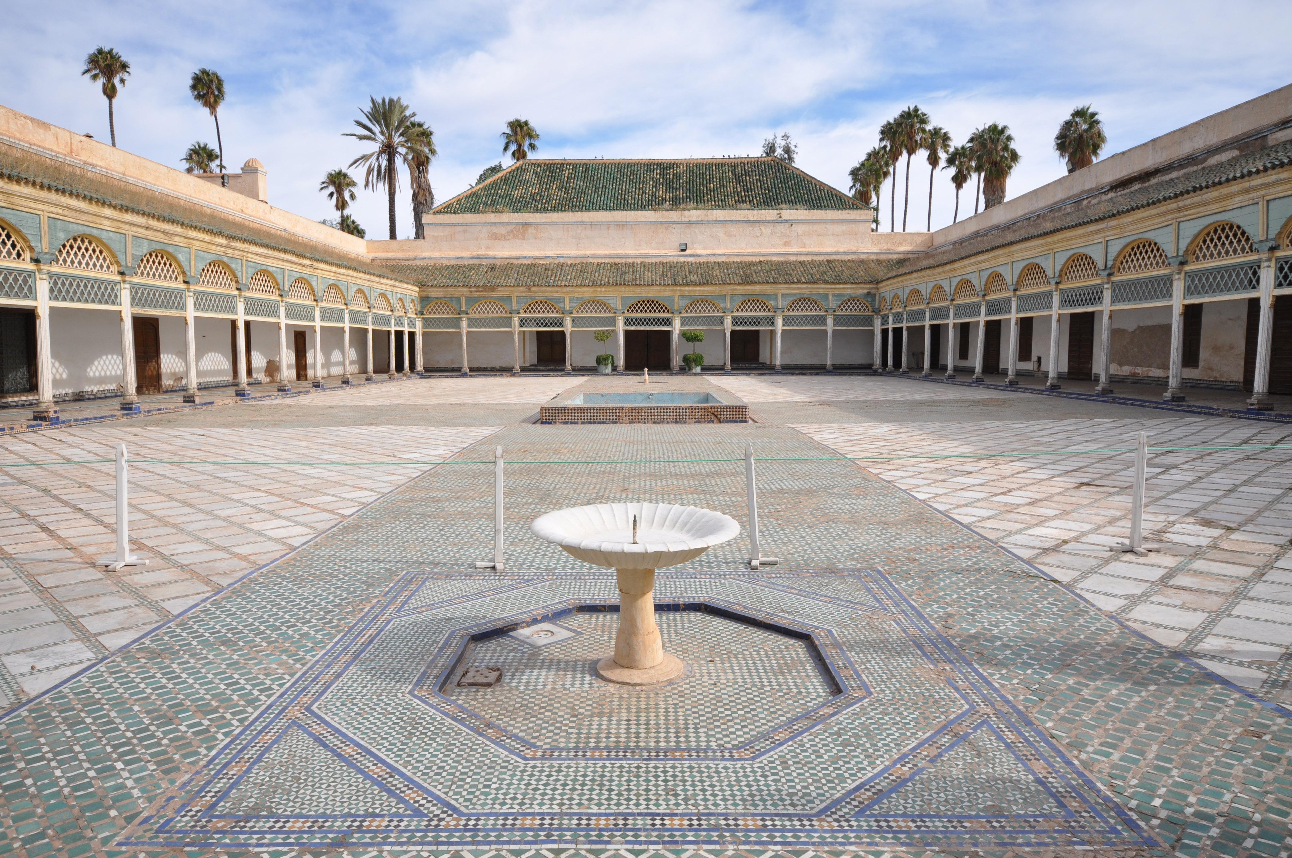 Ornate archways and tiles in a historic Marrakech riad courtyard